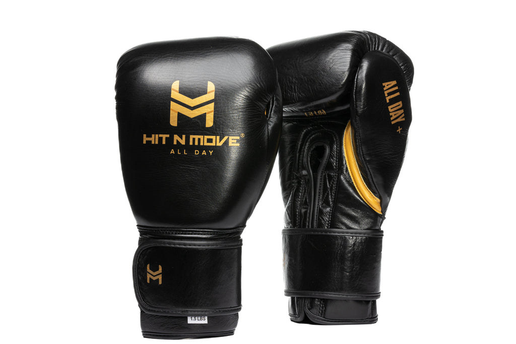 Black HIT'N'MOVE 24 oz conditioning boxing gloves with gold logos and hook-and-loop straps, front and palm views