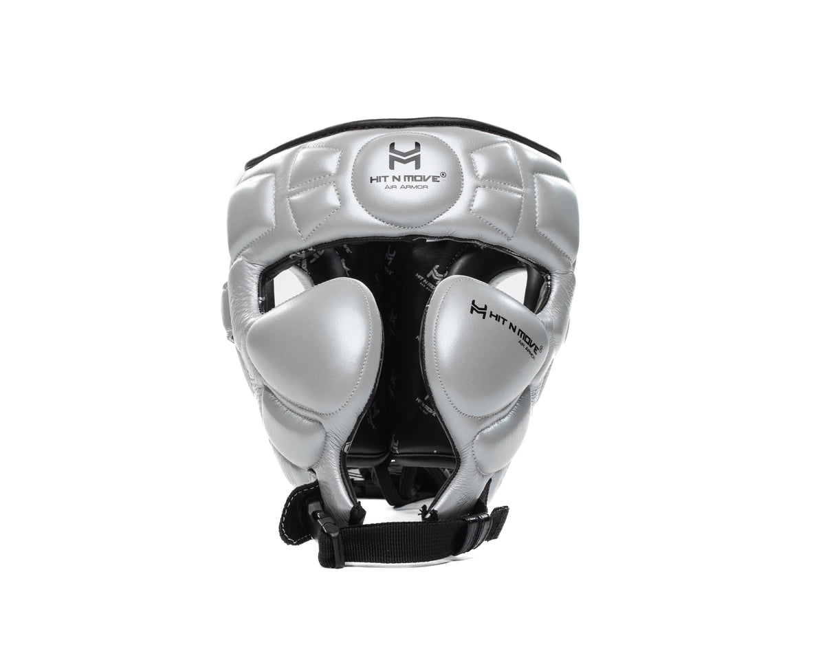 Silver HIT'N'MOVE Air Armor Precision boxing headgear with black logos, cheek padding and black chin strap, front view